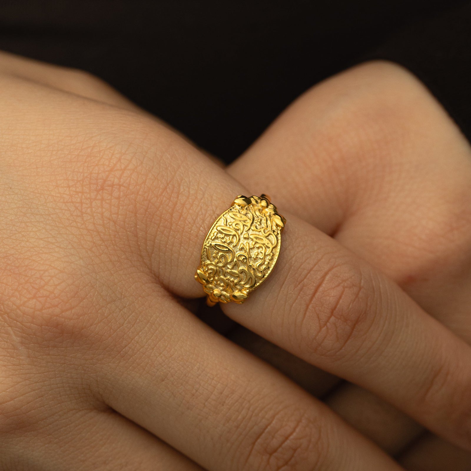 Close up photo of the "Walk to Me, and I'll run to you" Medallion Ring as worn by the model.