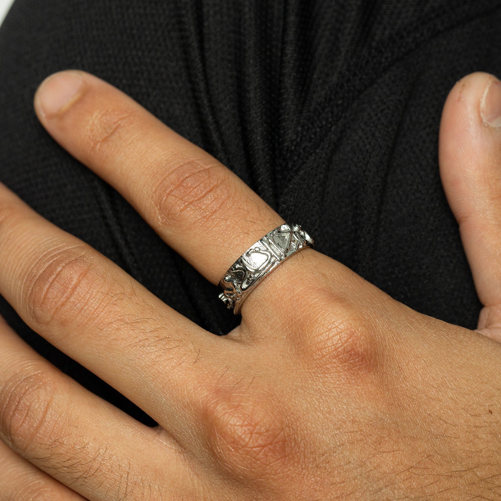 Close up of the silver "Perhaps you dislike what is good for you" Ring | Men on the model's left index finger.