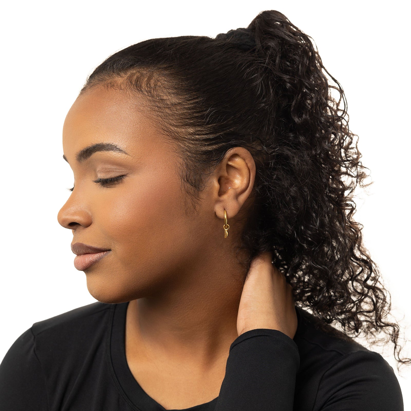 A model wearing the 18K gold-plated Watermelon Hoops. The earrings sit delicately on her earlobes, highlighting the vibrant watermelon design against her skin.