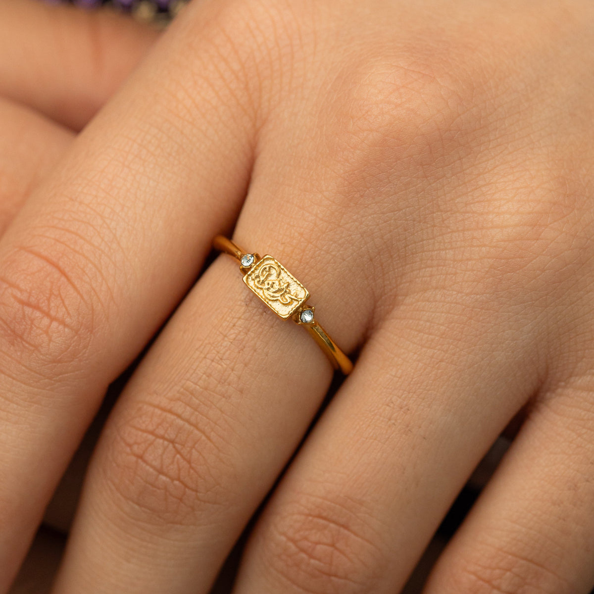 Close up of the We Are Strong ring as the model wears it.