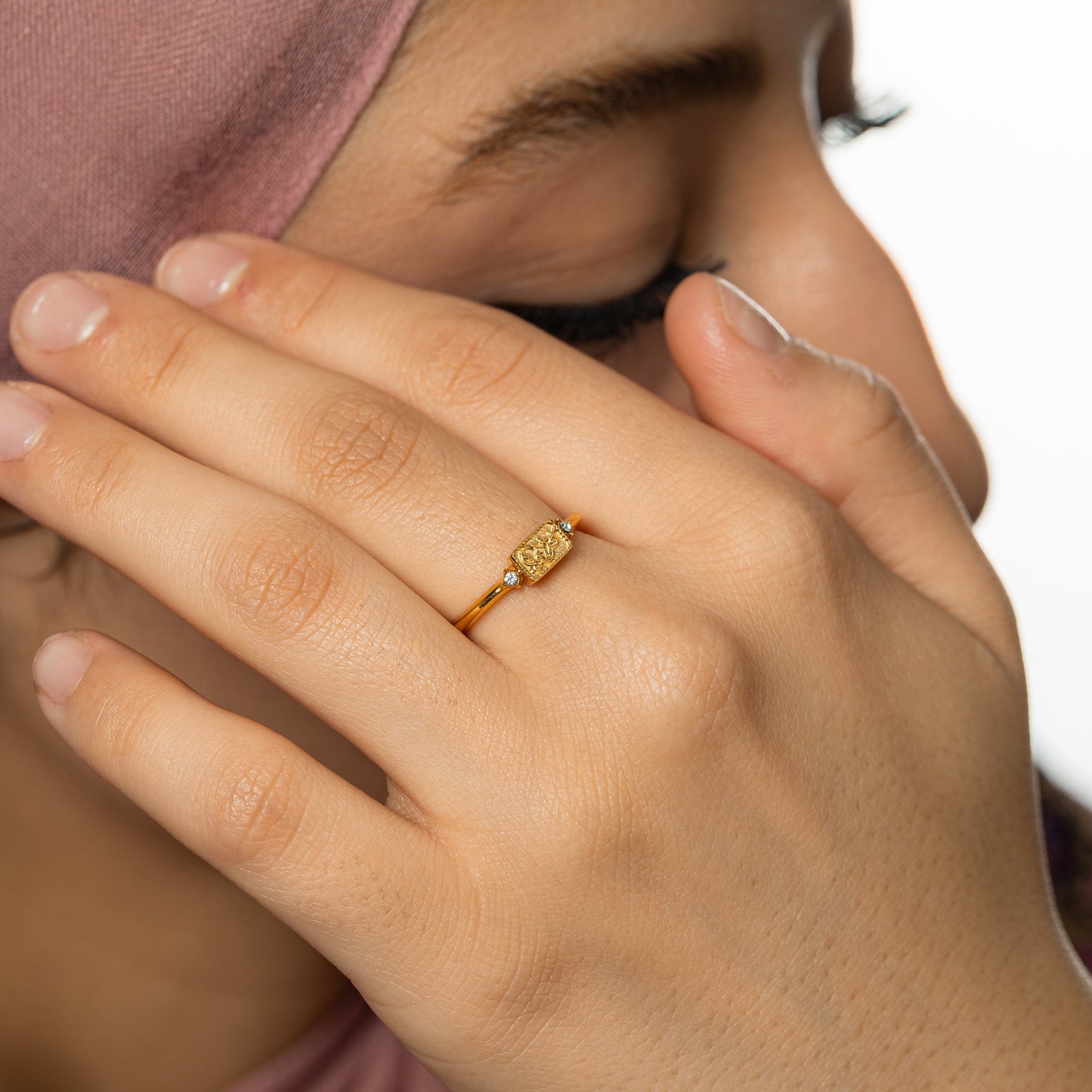 Close up of the ring as the model wears it on their finger.