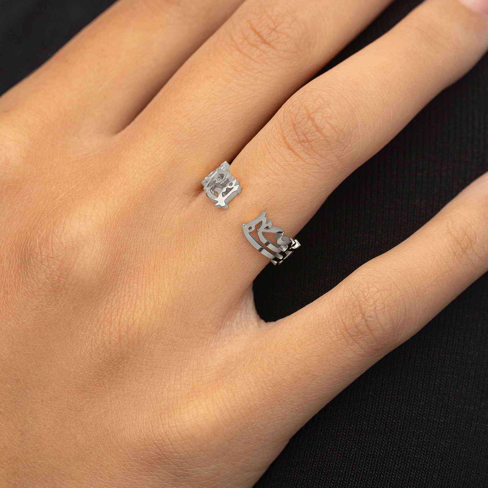 Silver “What Makes You Different Makes You Beautiful” Calligraphy Ring styled on the hand, open-band design visible facing outward.