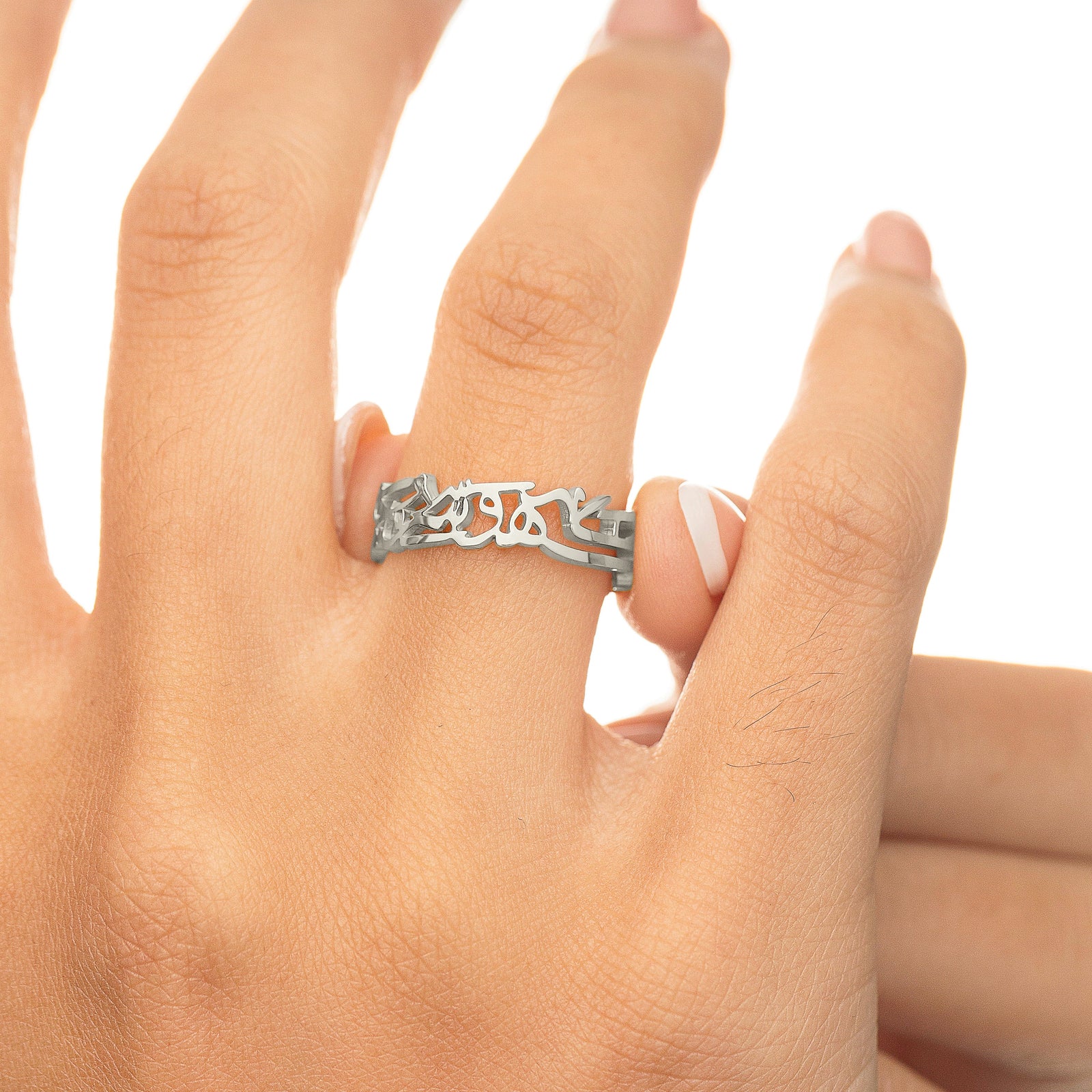 Silver “What Makes You Different Makes You Beautiful” Calligraphy Ring worn on the hand, showing the calligraphy design across the band.