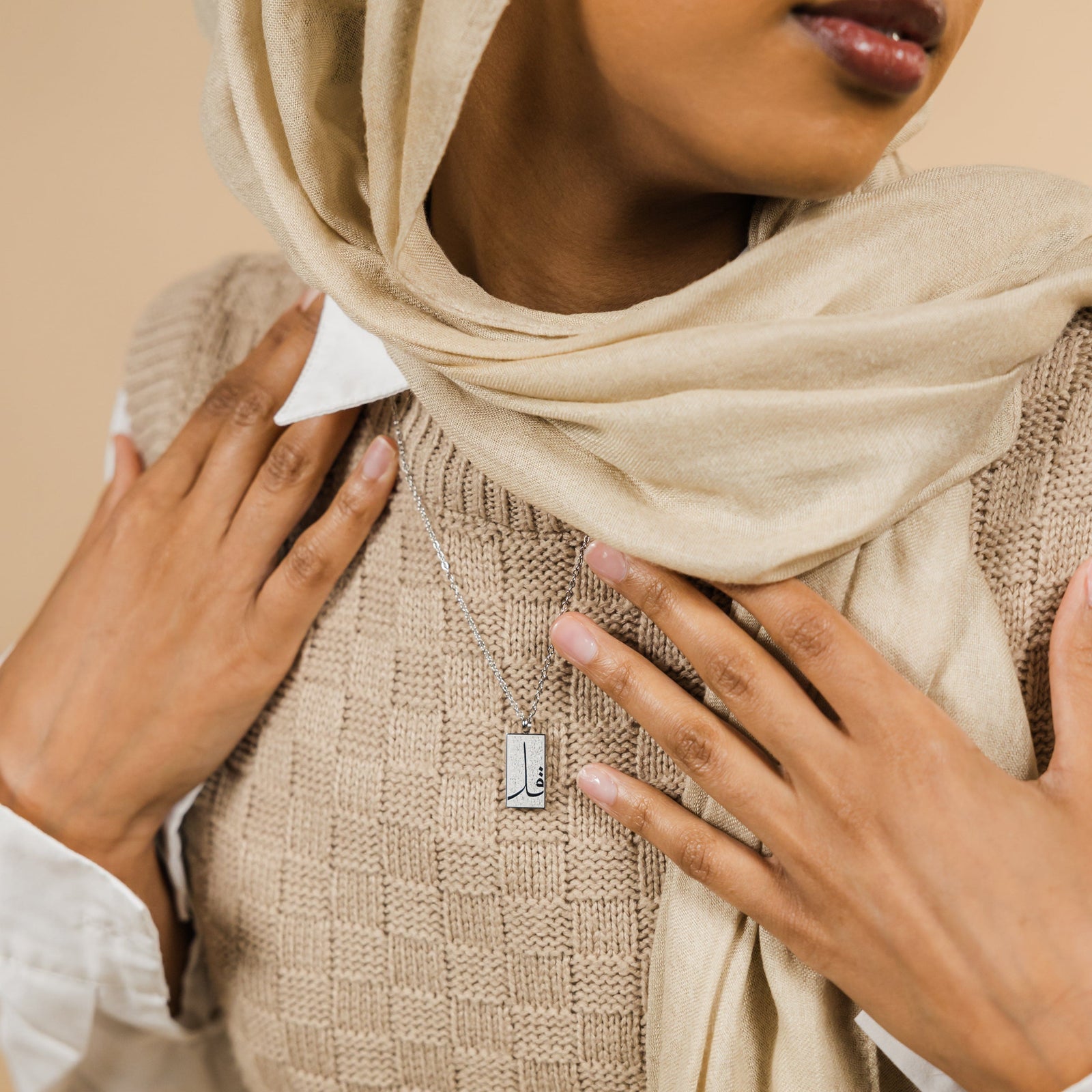 The silver '4 Qul' Tag Necklace | Women as worn by the model.
