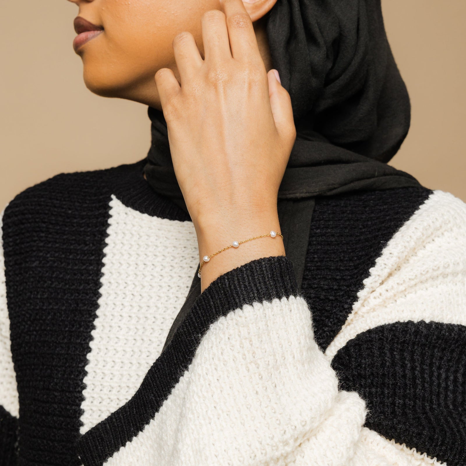 Photo of the model wearing the Pearl Strand Bracelet on their left wrist.