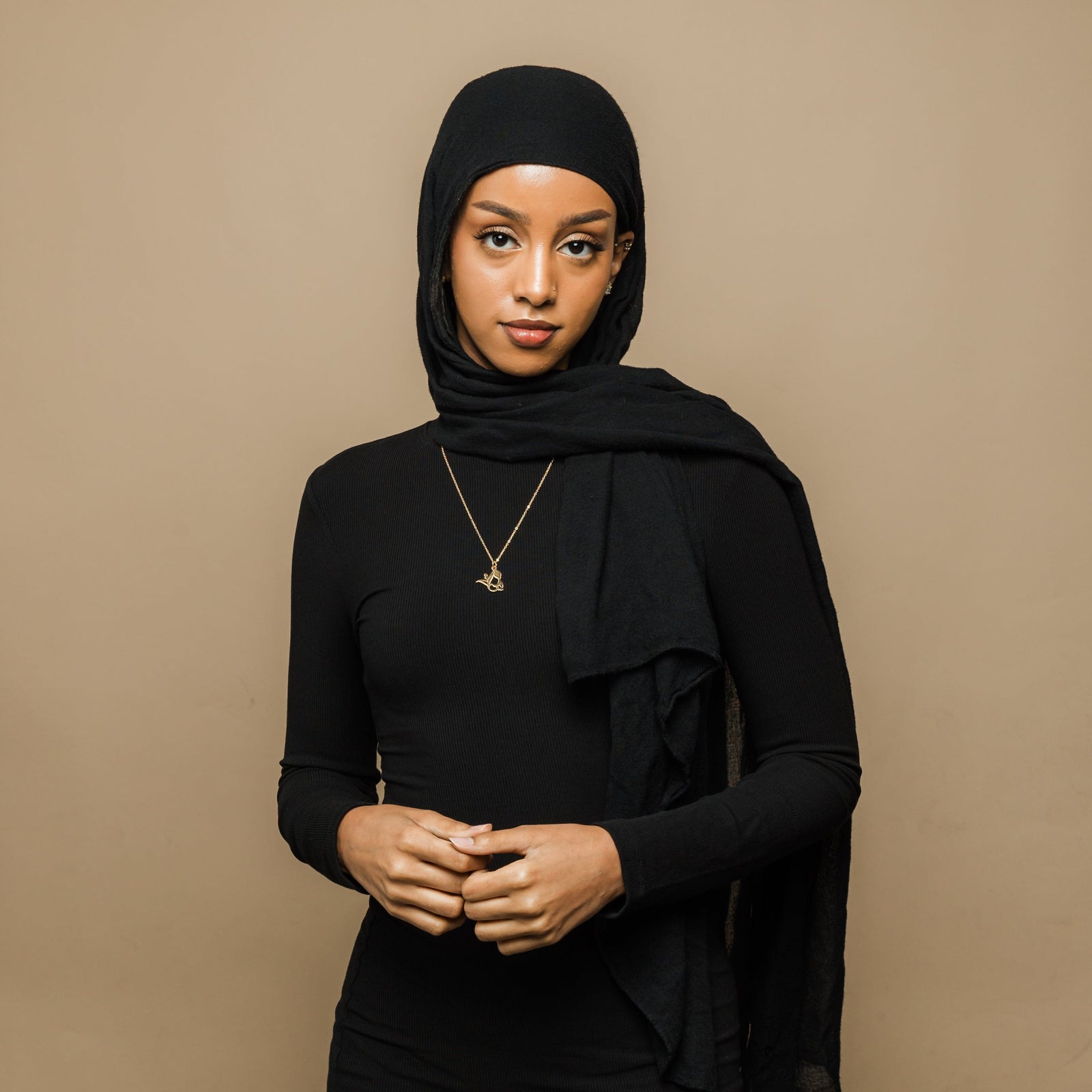 Photo of the model wearing the gold Ready Calligraphy Name Necklace