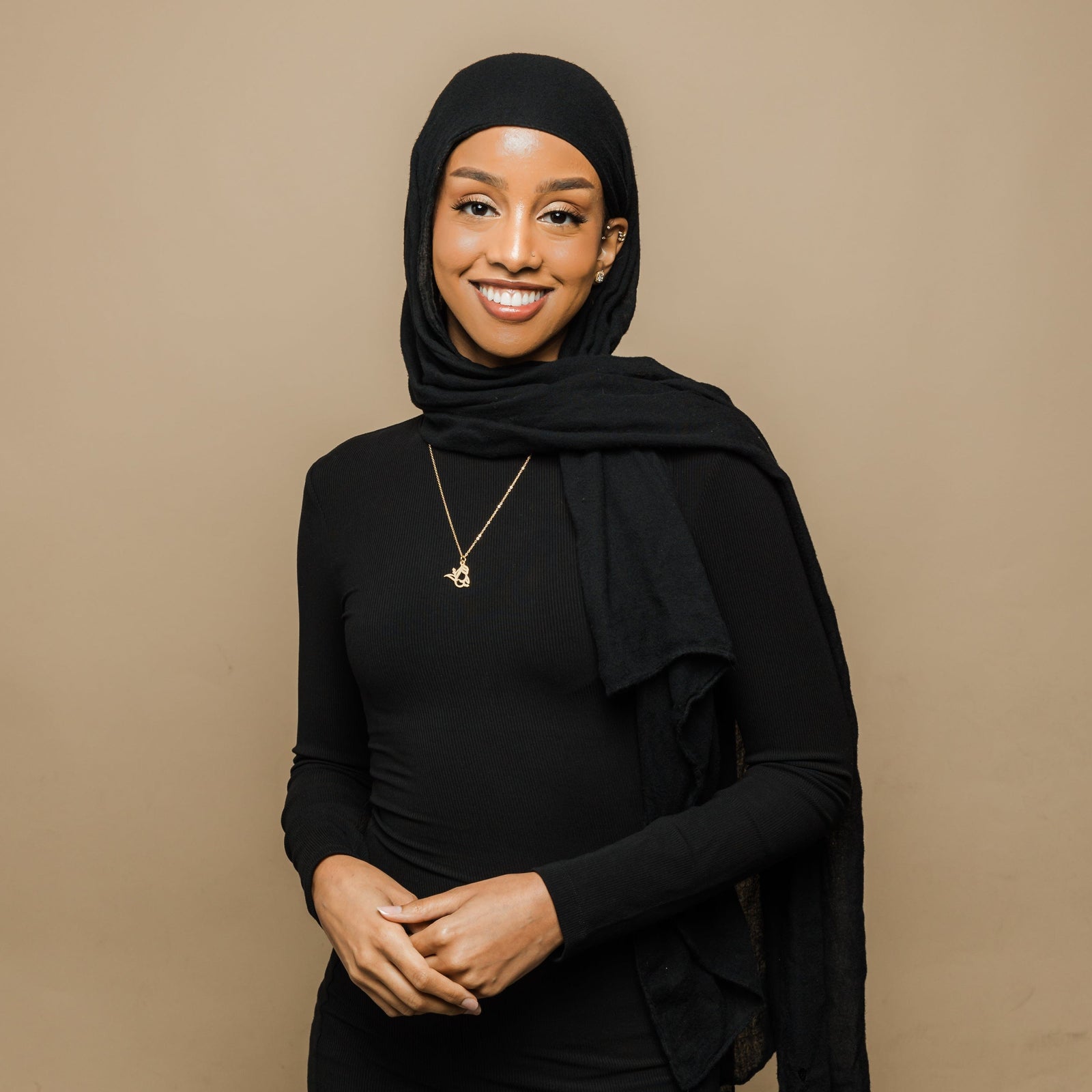 Photo of the model wearing the gold Ready Calligraphy Name Necklace