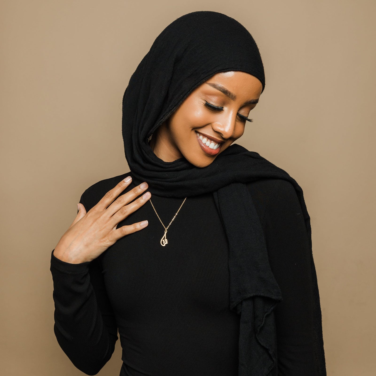 Photo of the model wearing the gold Ready Calligraphy Name Necklace