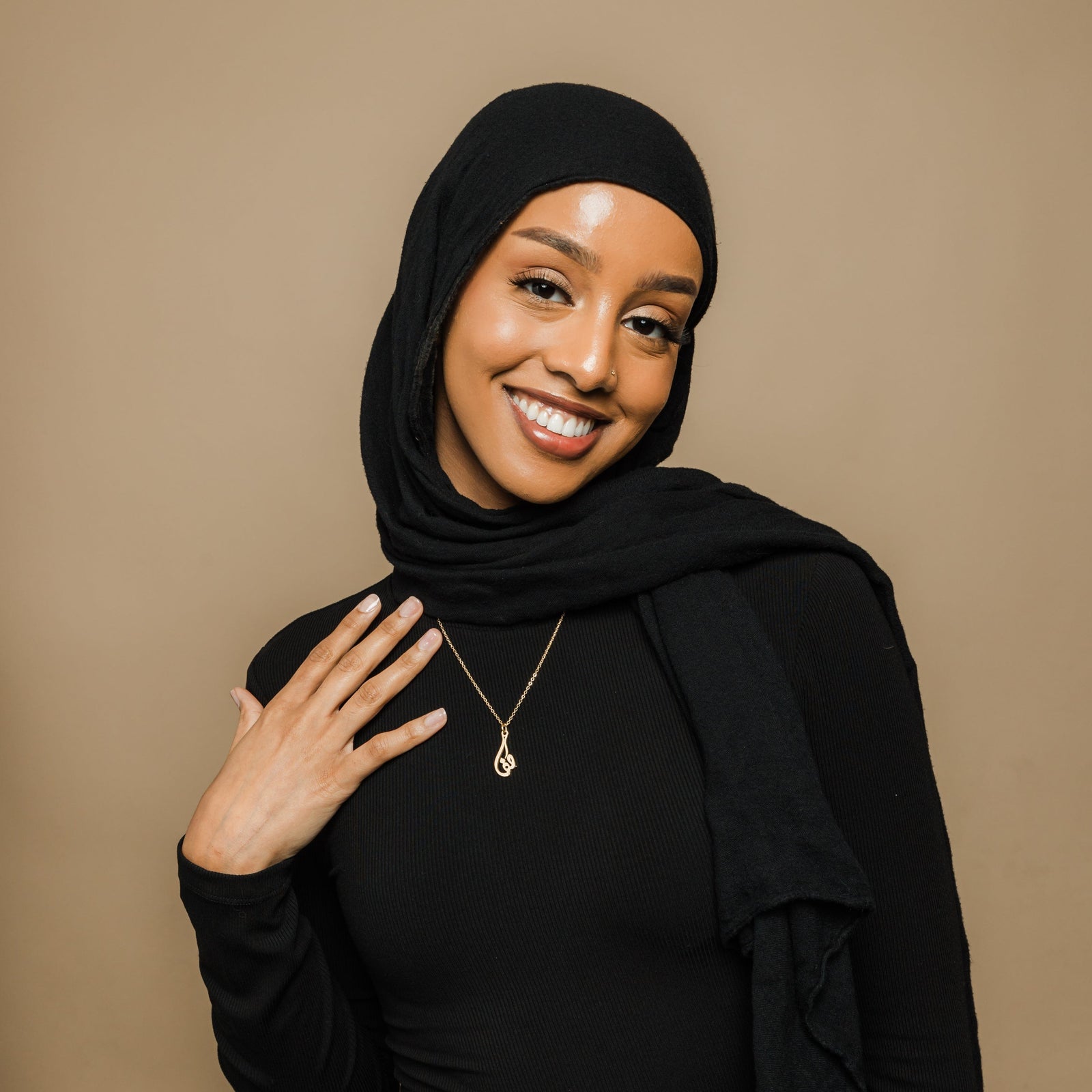 Photo of the model wearing the gold Ready Calligraphy Name Necklace