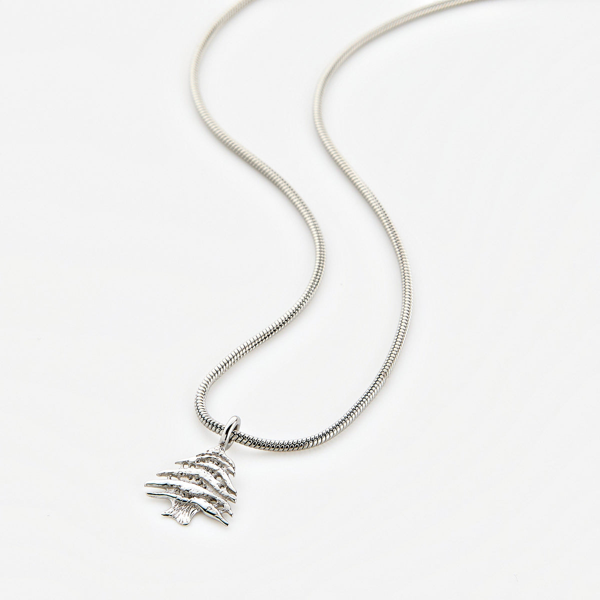 Silver necklace with a Cedar of Lebanon tree pendant, displayed on a white background.