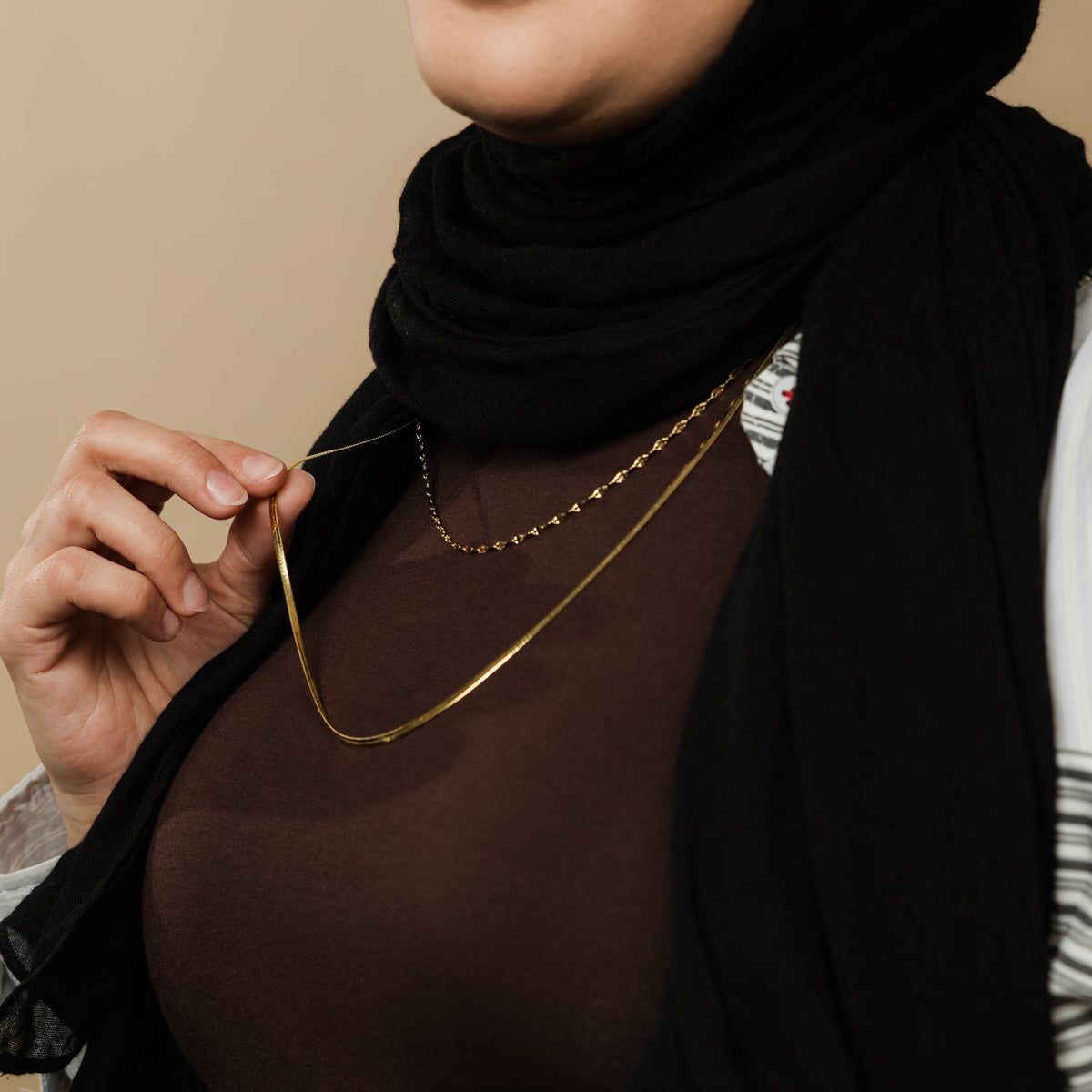 The gold Herringbone & Flutter Layering Set as worn by the model.