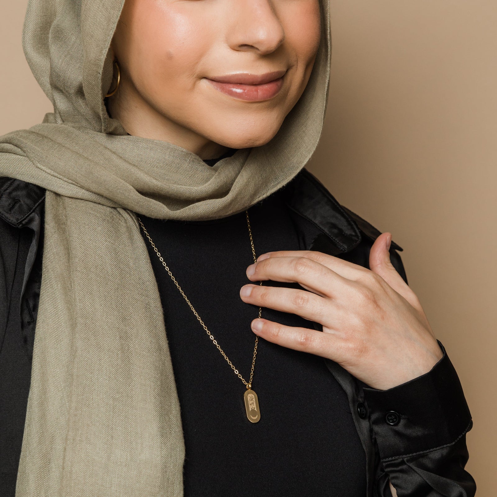 Photo do the gold Alhamdulillah Moon Necklace as worn by the model.