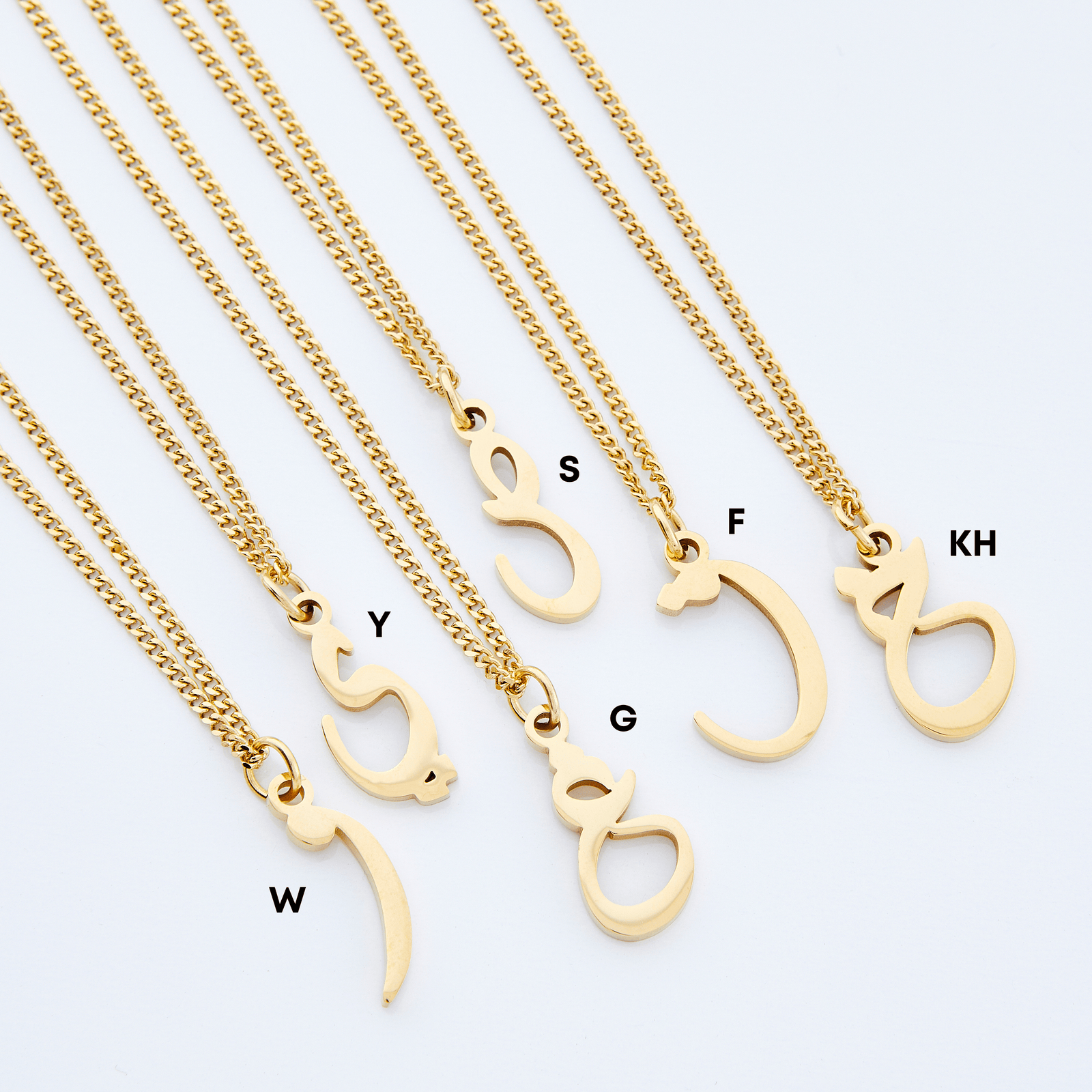 Flat lay of six gold Hanging Arabic Letter Necklaces featuring W, Y, G, S, F, and KH letters.