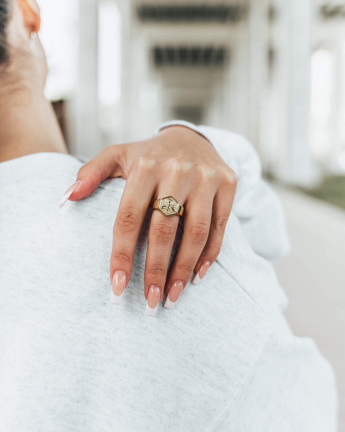 Close up of the Nahla Ring as worn by the model on their left middle finger.
