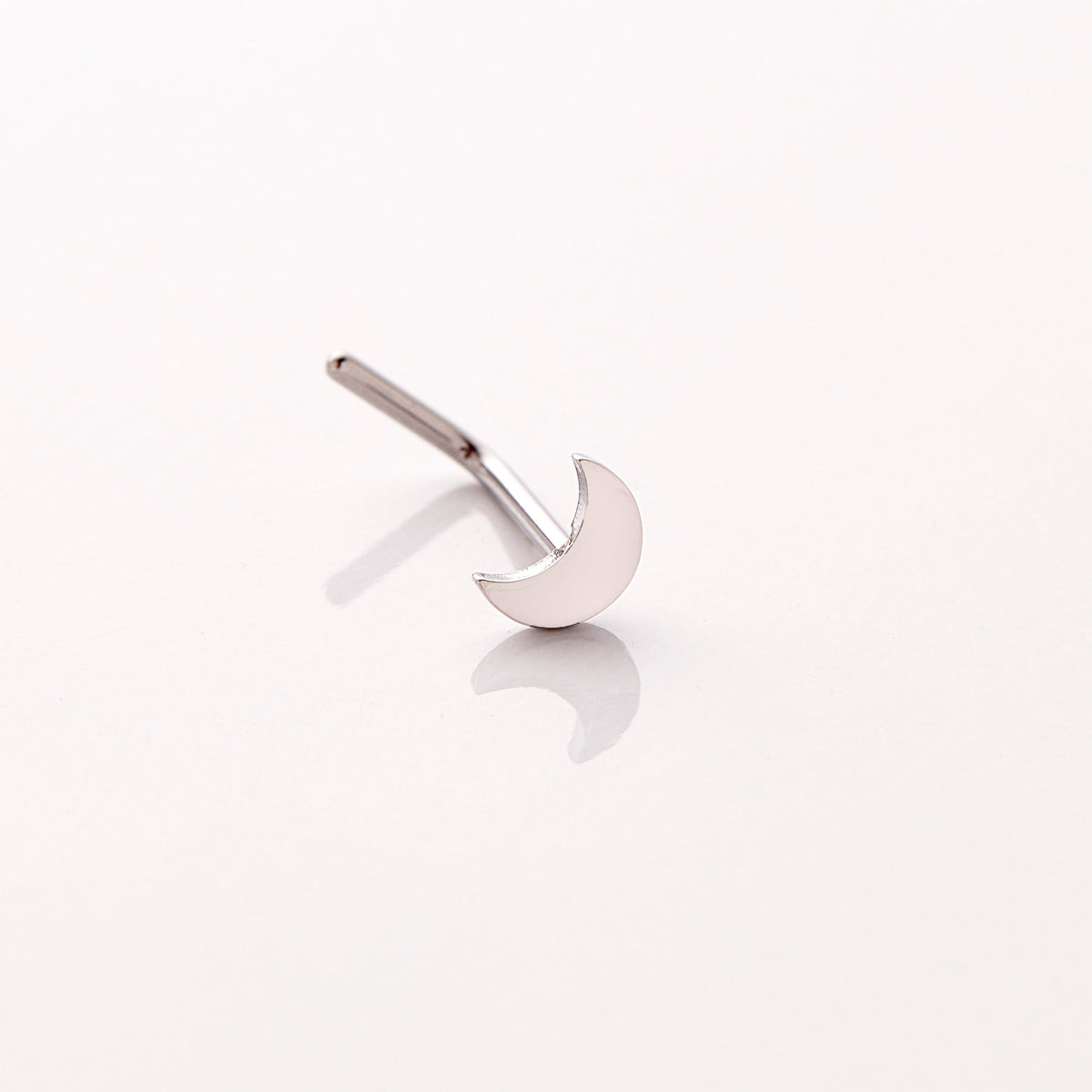 Photo of a silver nose ring that features design of a gorgeous moon that provides light in dark times