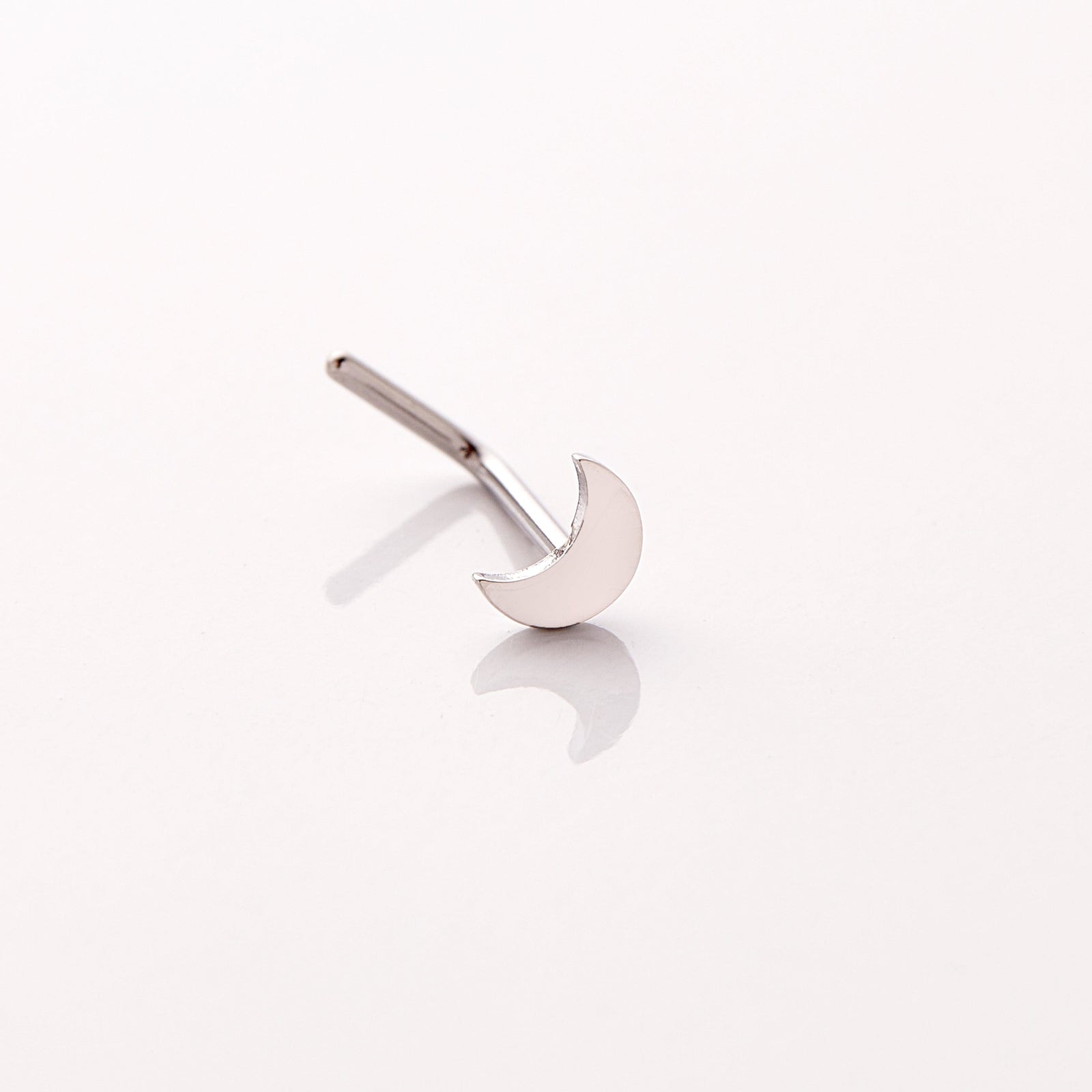 Photo of a silver nose ring that features design of a gorgeous moon that provides light in dark times