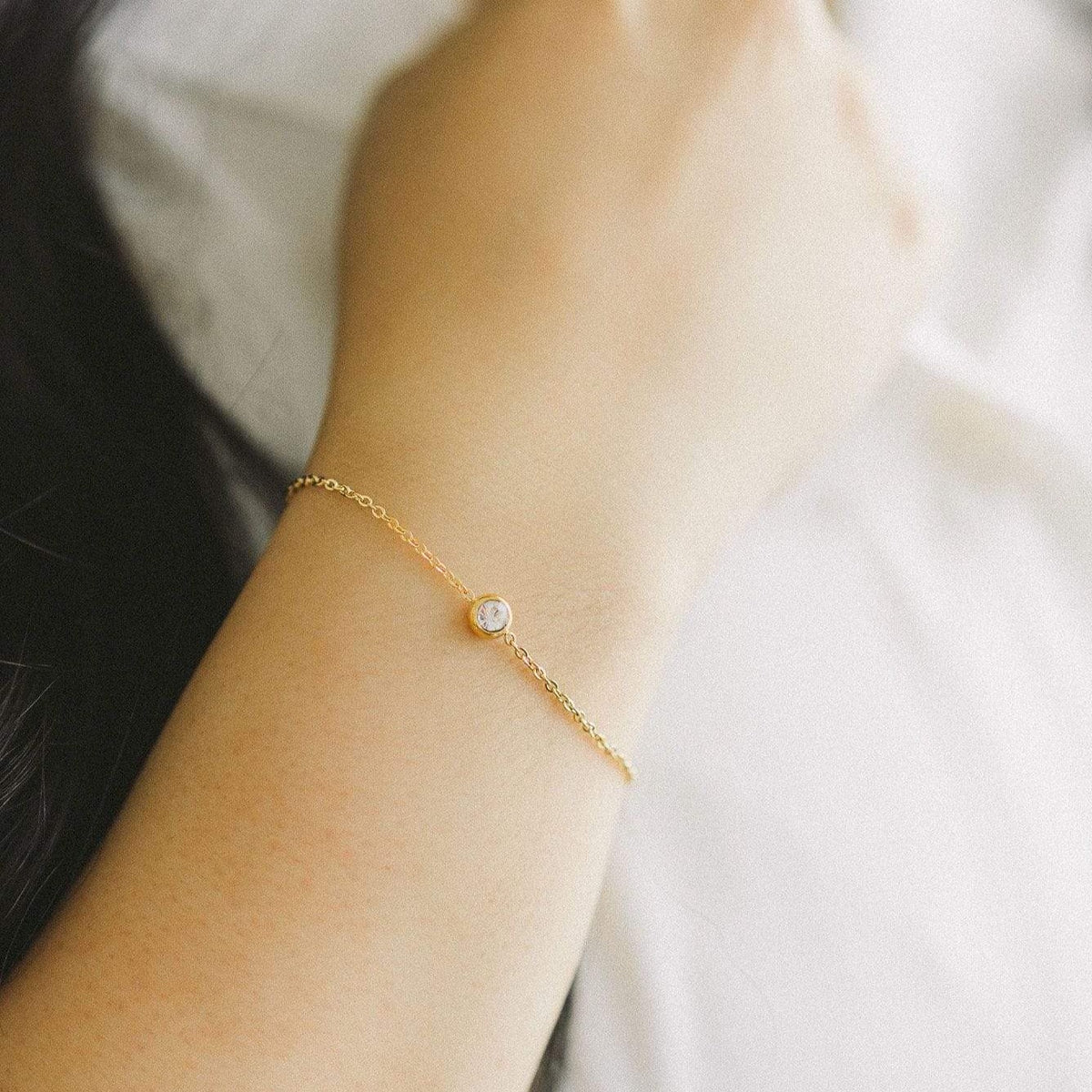 Close up of the Bezel Bracelet as worn by the model.