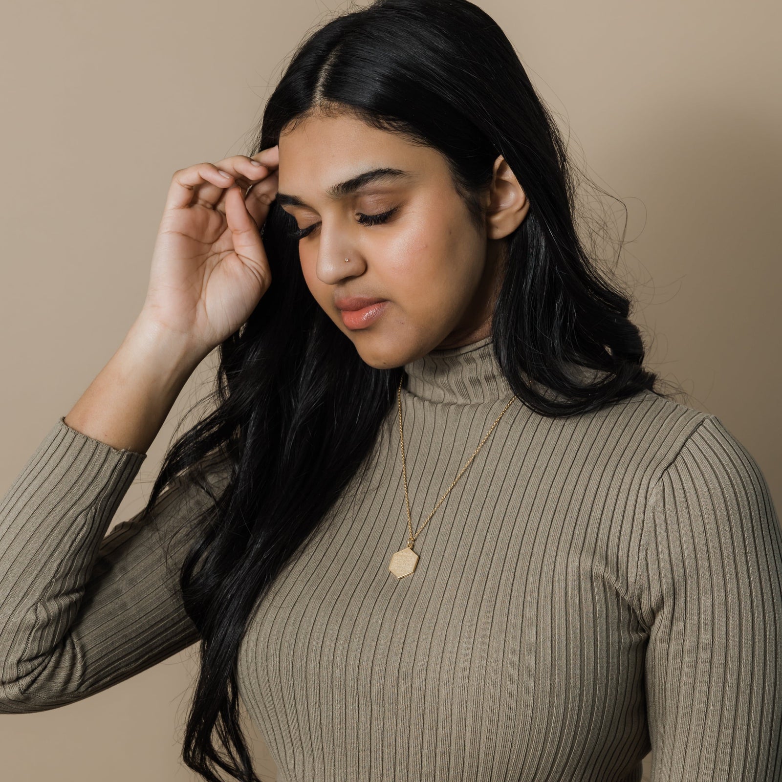 Photo of the model wearing the gold Surat Al-Fatiha Necklace.