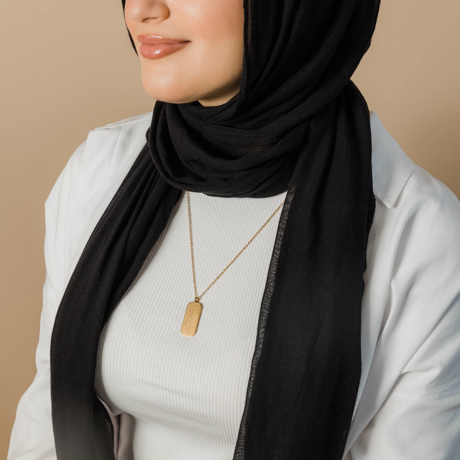 Model wearing the gold Ayatul Kursi Tag necklace.