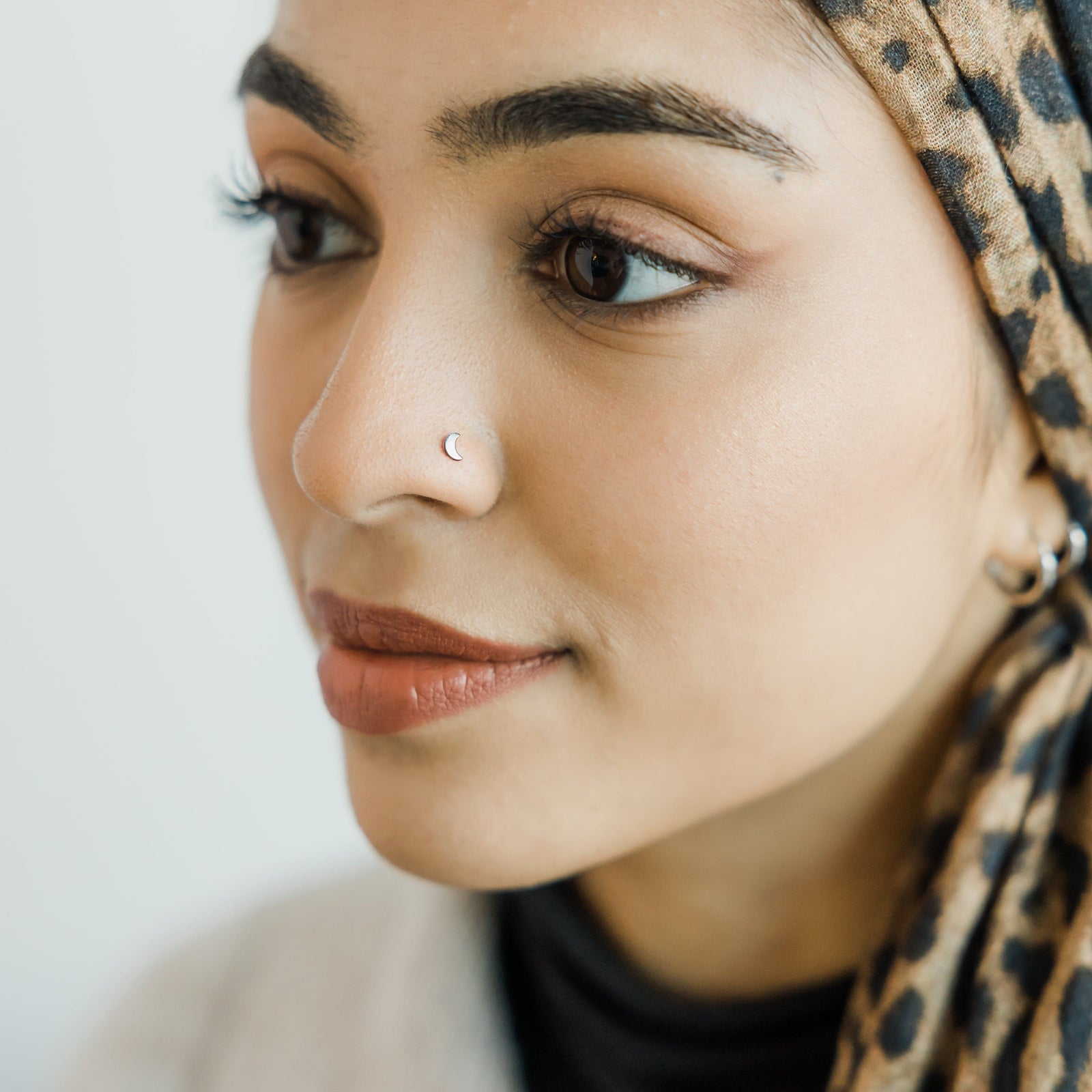 Photo of the model wearing the silver Crescent Stud Nose Ring.