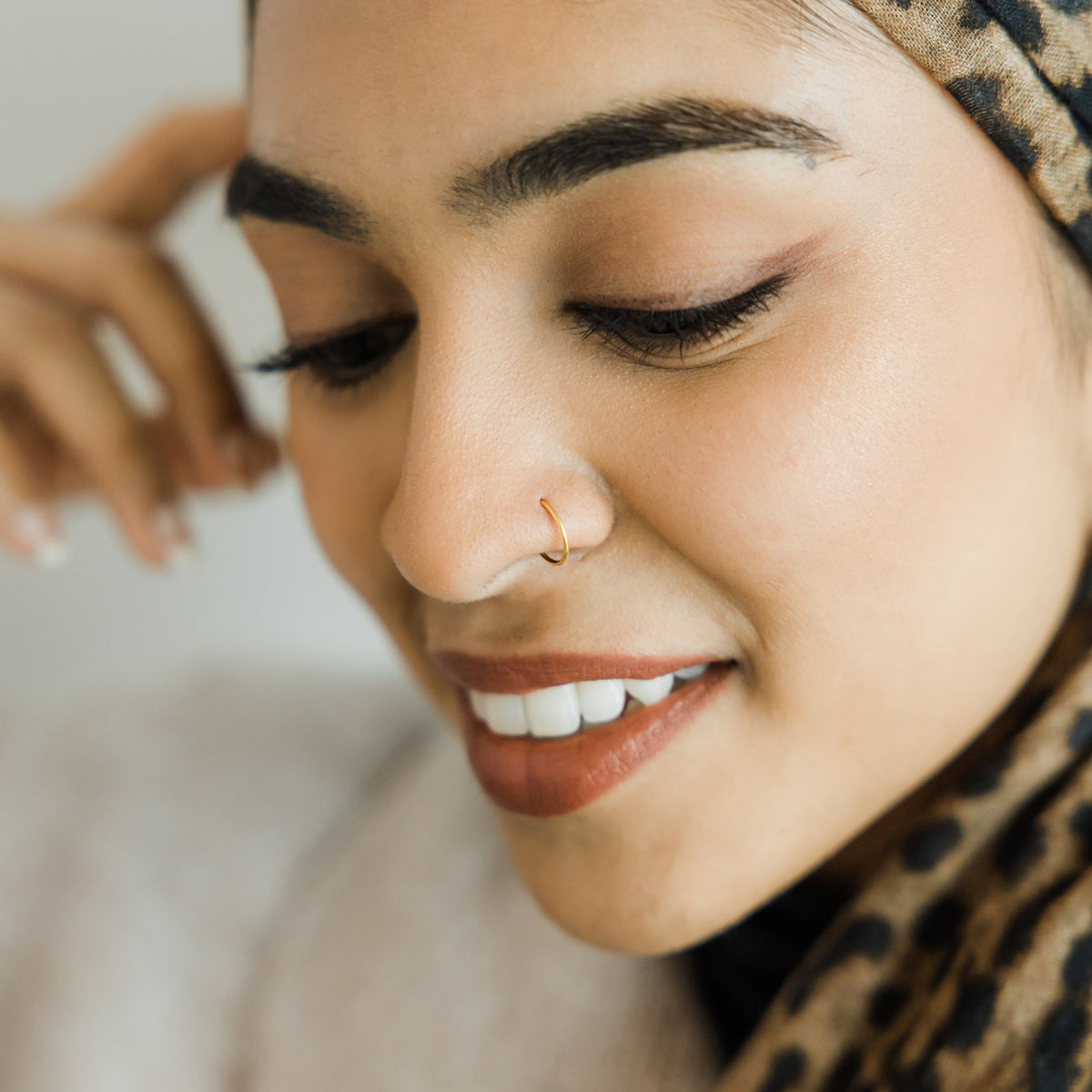 Photo of the model wearing the  gold Classic Nose Hoop.