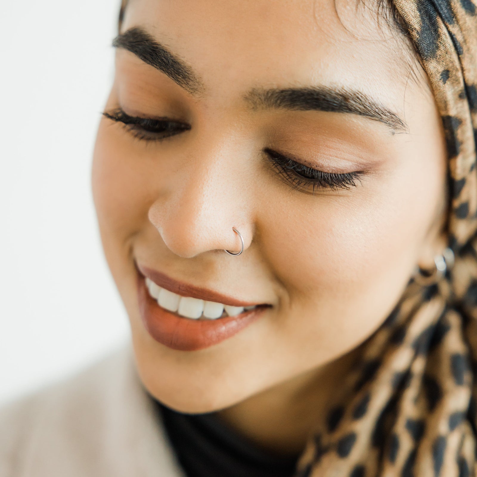 Photo of the model wearing the silver Classic Nose Hoop.