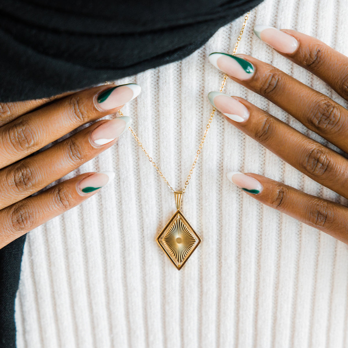 Close up of the gold Sun Rays Necklace as worn by the model