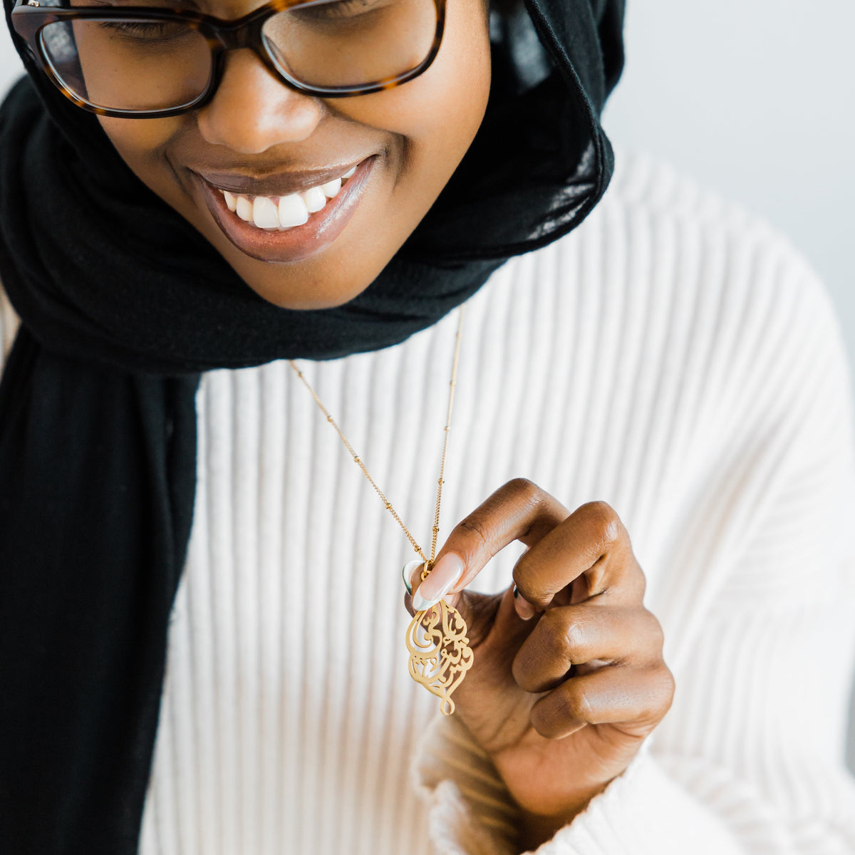 Photo of the model wearing the gold "I Am Near" Necklace.