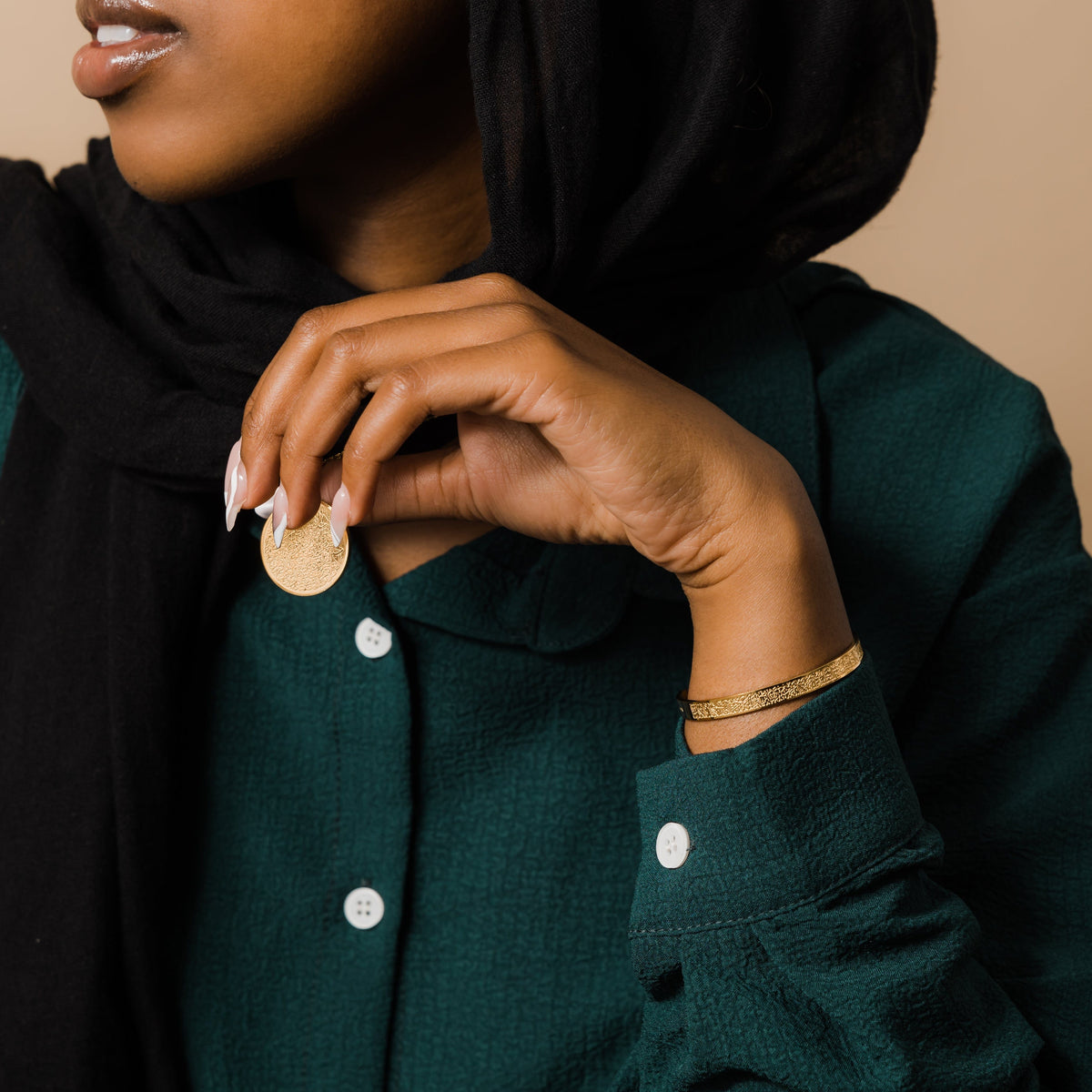 Photo of the model wearing the gold Ayatul Kursi necklace and Ayatul Kursi Cuff