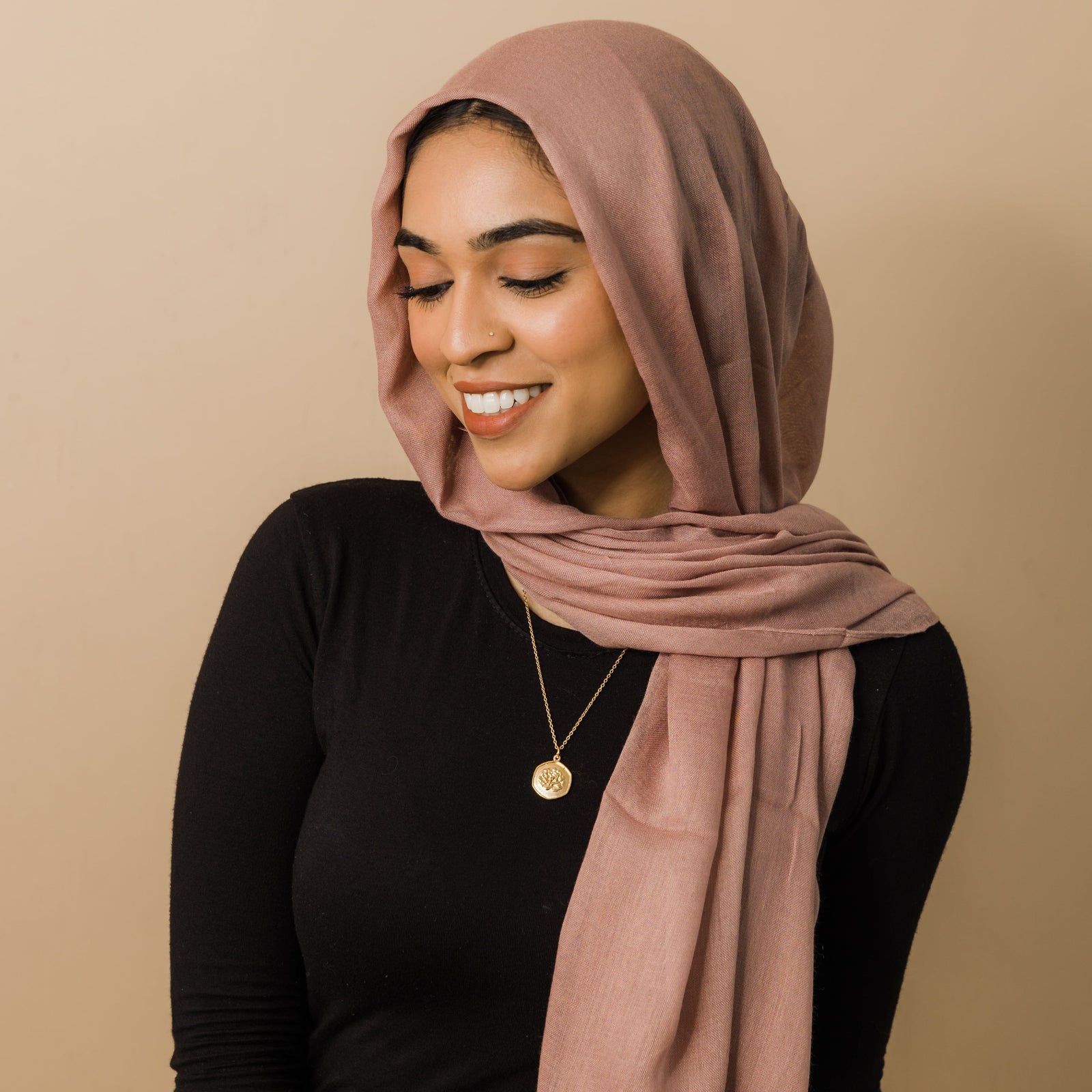 Photo of the model wearing the gold January | Birth Flower Pendant.