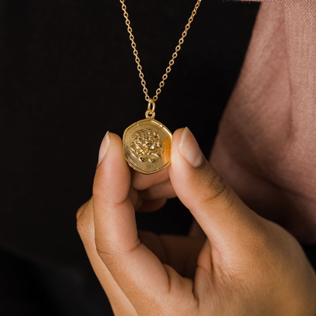 Close up of the gold January | Birth Flower Pendant.