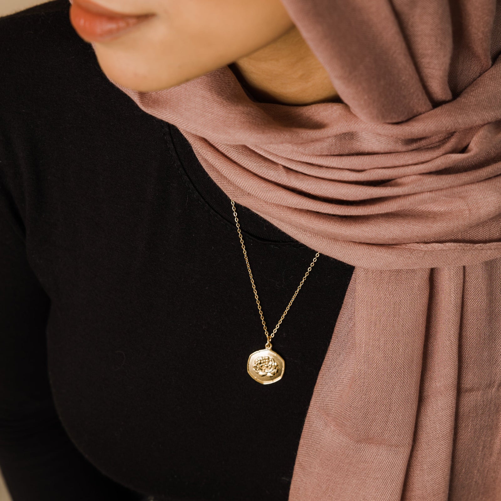 The gold January | Birth Flower Pendant as worn by the model.