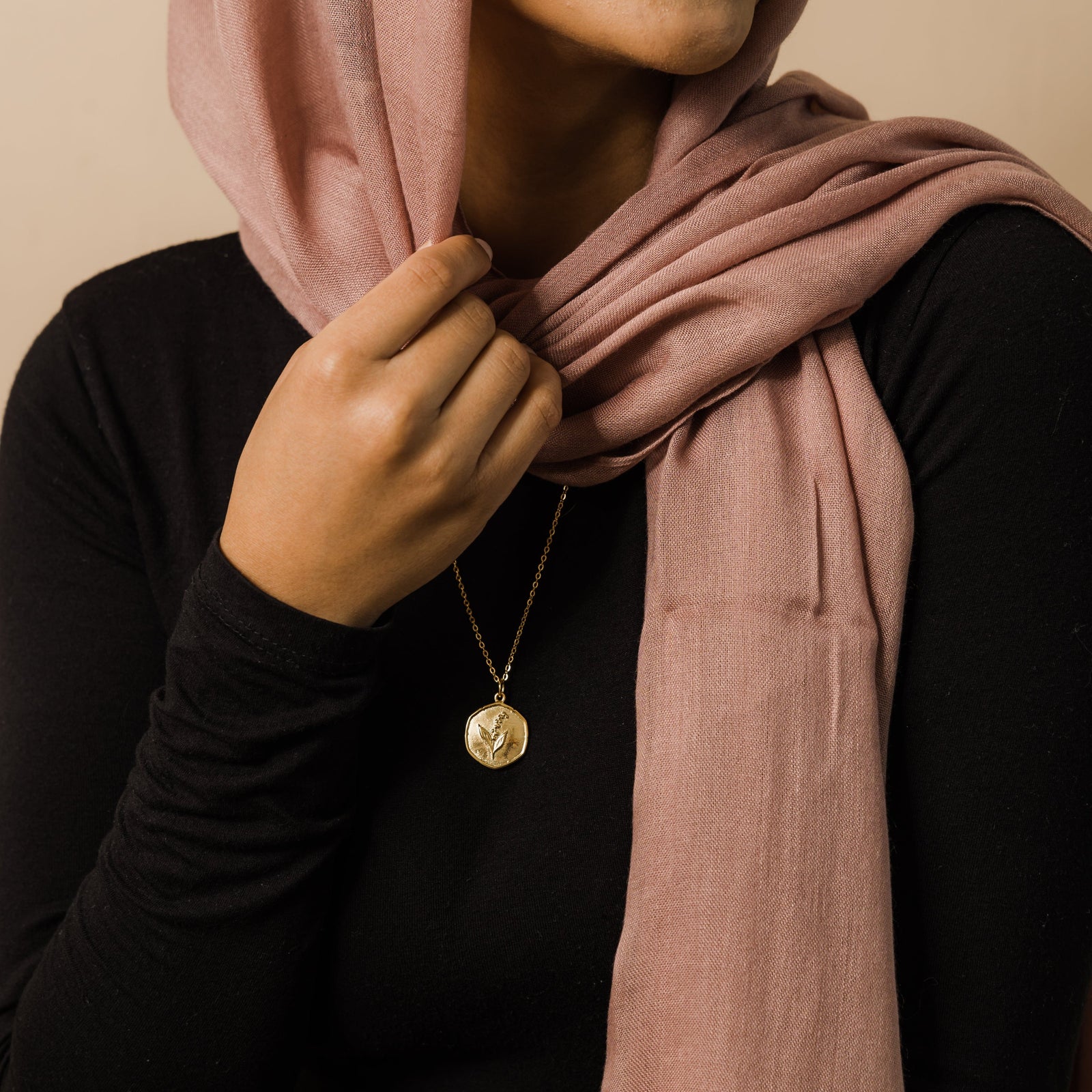 Photo of the gold May | Birth Flower Pendant as worn by the model.