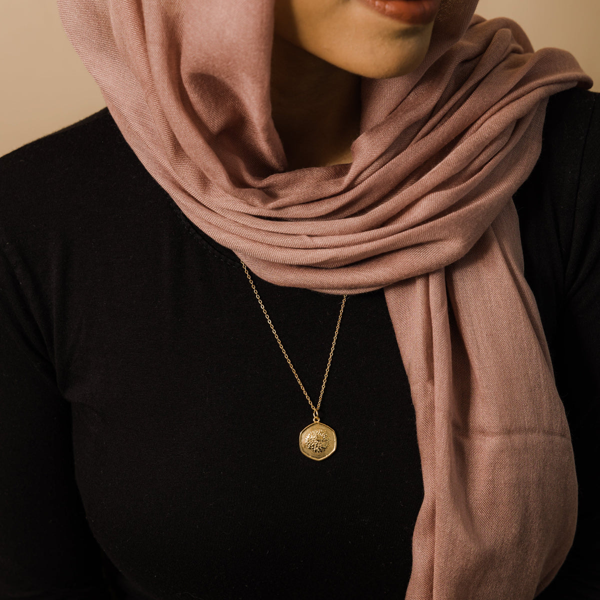 The gold September | Birth Flower Pendant as worn by the model.