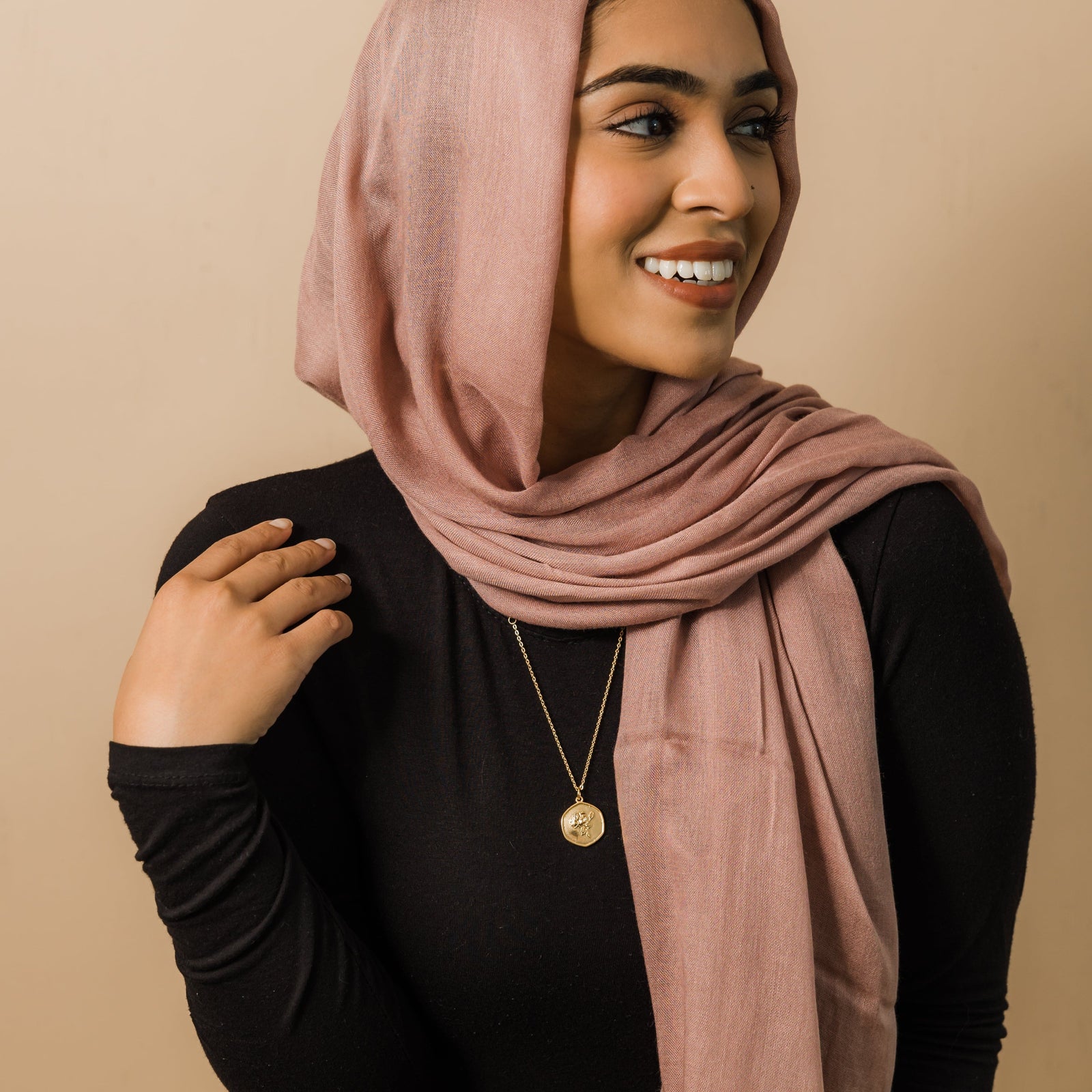 Photo of the model wearing the gold October | Birth Flower Pendant.