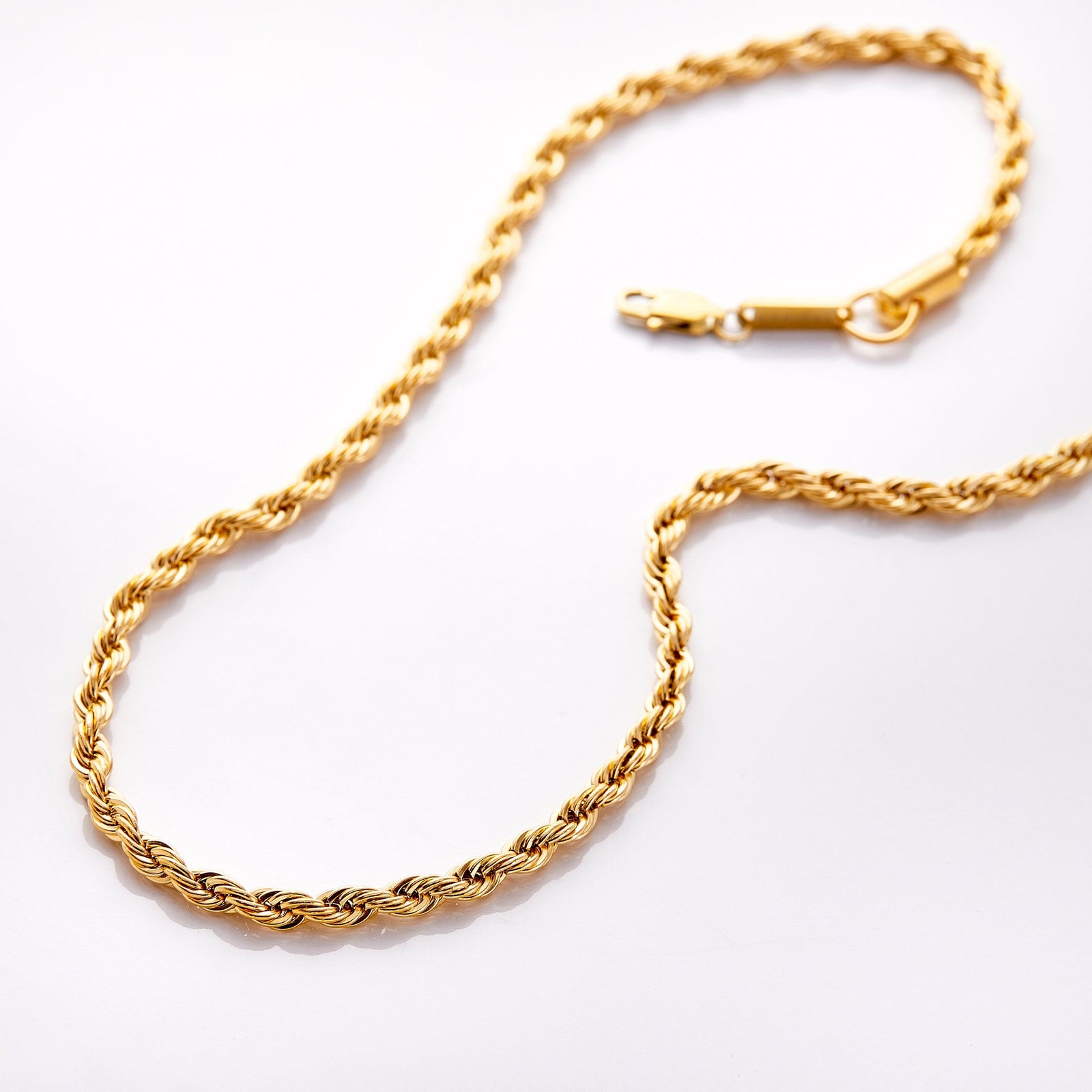 Gold rope chain necklace with thicker links, displayed flat on a white background with lobster clasp.