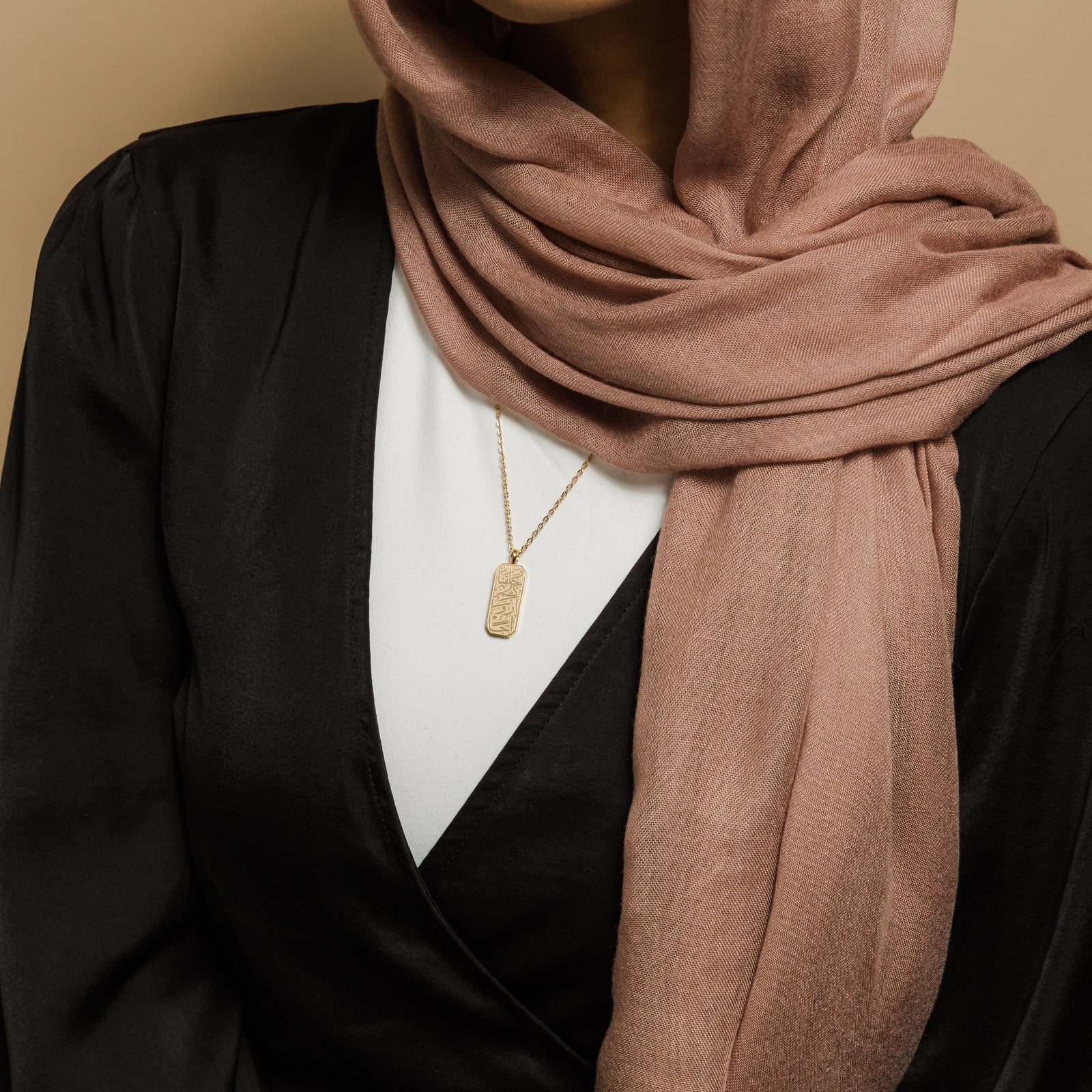Close up of the gold 'And We Created You In Pairs' Tag Necklace as worn by the model 