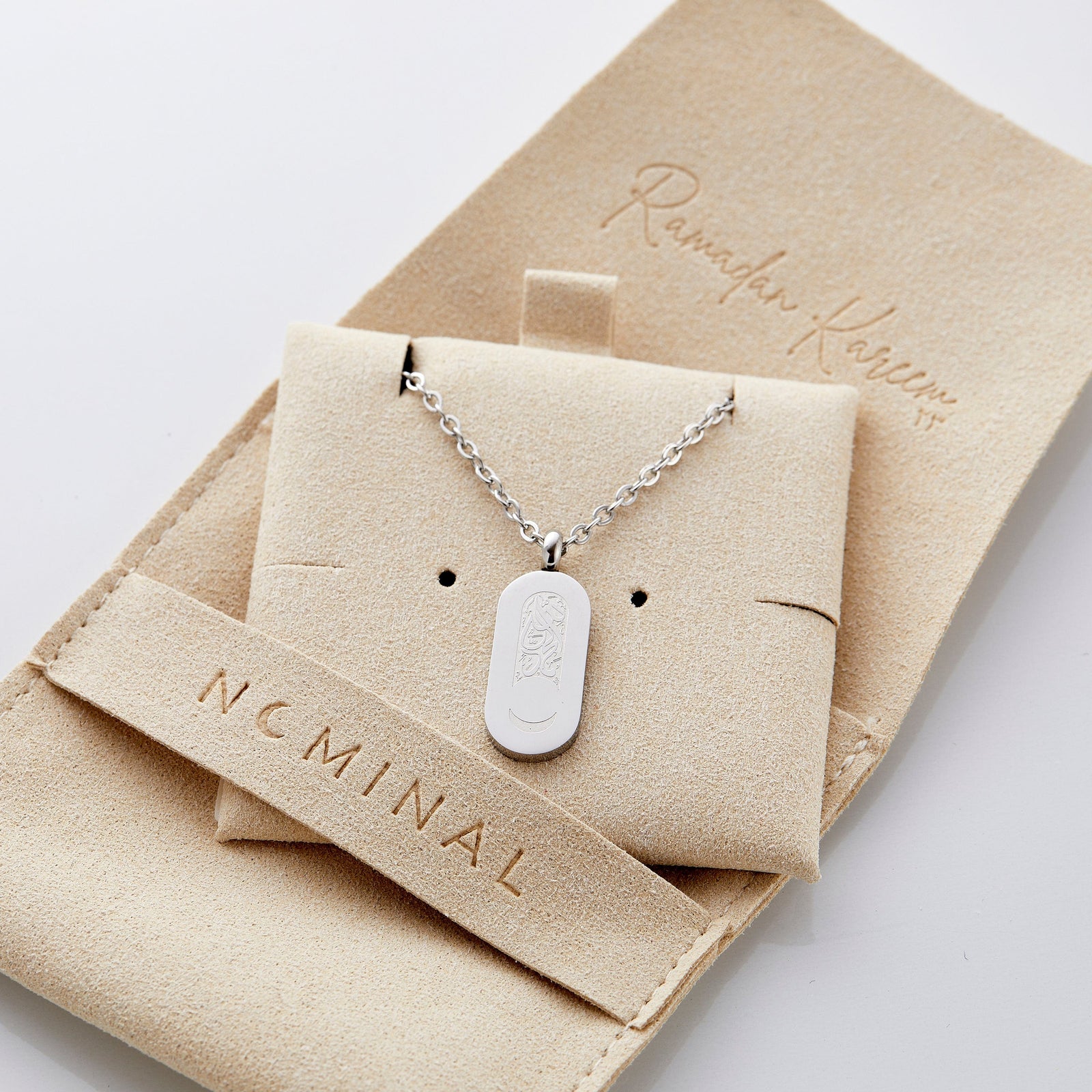 Close up of the silver Alhamdulillah Moon Necklace | Women on its packaging.